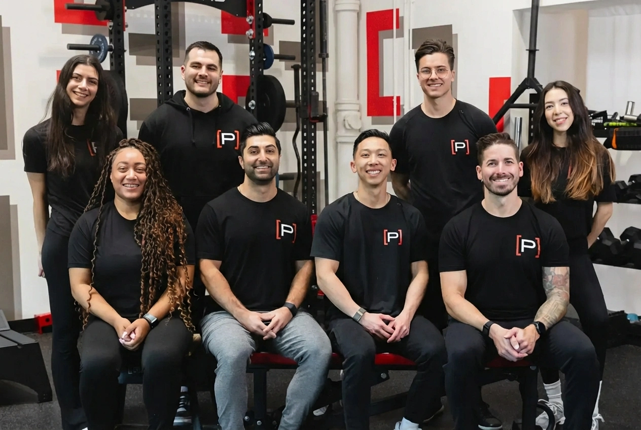 Team of physical therapists at Prehab Physical Therapy assisting a patient.